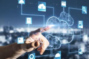 A hand touches a virtual cloud icon, surrounded by digital connection lines and icons—representing managed IT Services in Contra Costa County, CA, with a focus on secure cloud computing and data transfer in a futuristic, technology-driven setting.