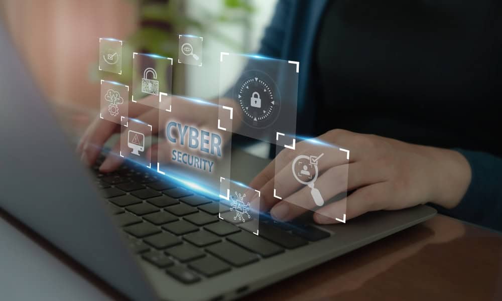 Hands typing on a laptop keyboard with digital cybersecurity icons and the words "CYBER SECURITY" displayed, representing online security, data protection technology, and managed IT services in Contra Costa County, CA.
